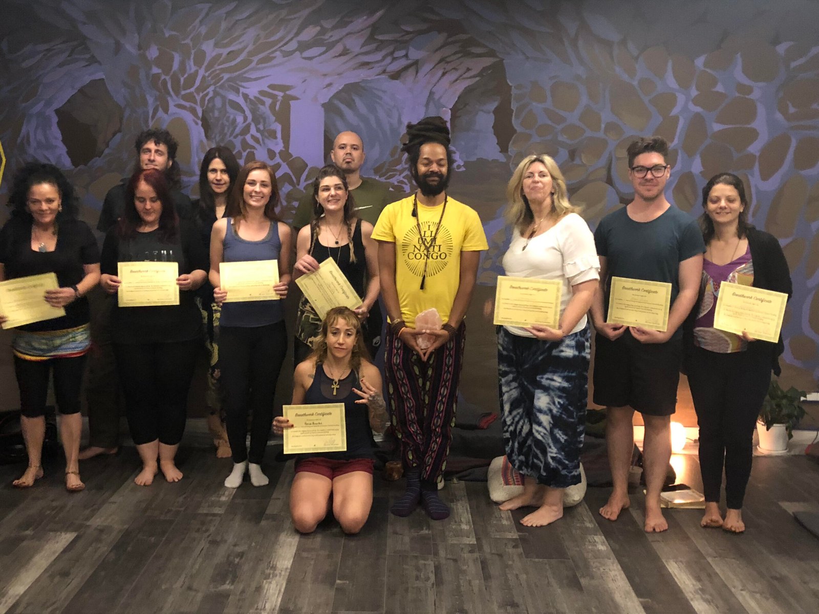 Graduating cohort holding their Rebirthing Breathwork certificates